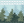 Close-up of green fabric with light green stitching forest pattern, a color swatch picture