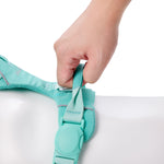 Hand holding padded vegan leather control handle on Soul and Tail Mint Green dog harness