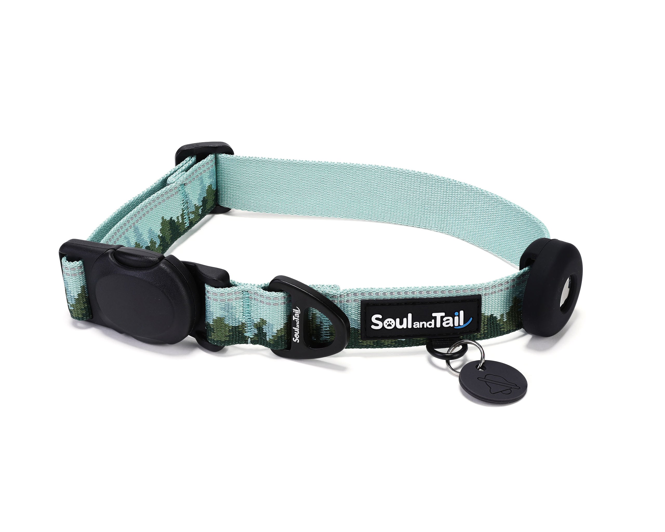 Green dog collar with forest mist pattern on its webbing, integrated with a black tag silencer, aluminum ring, silicon airtag holder, assembled by an black magnetic buckle on a white background