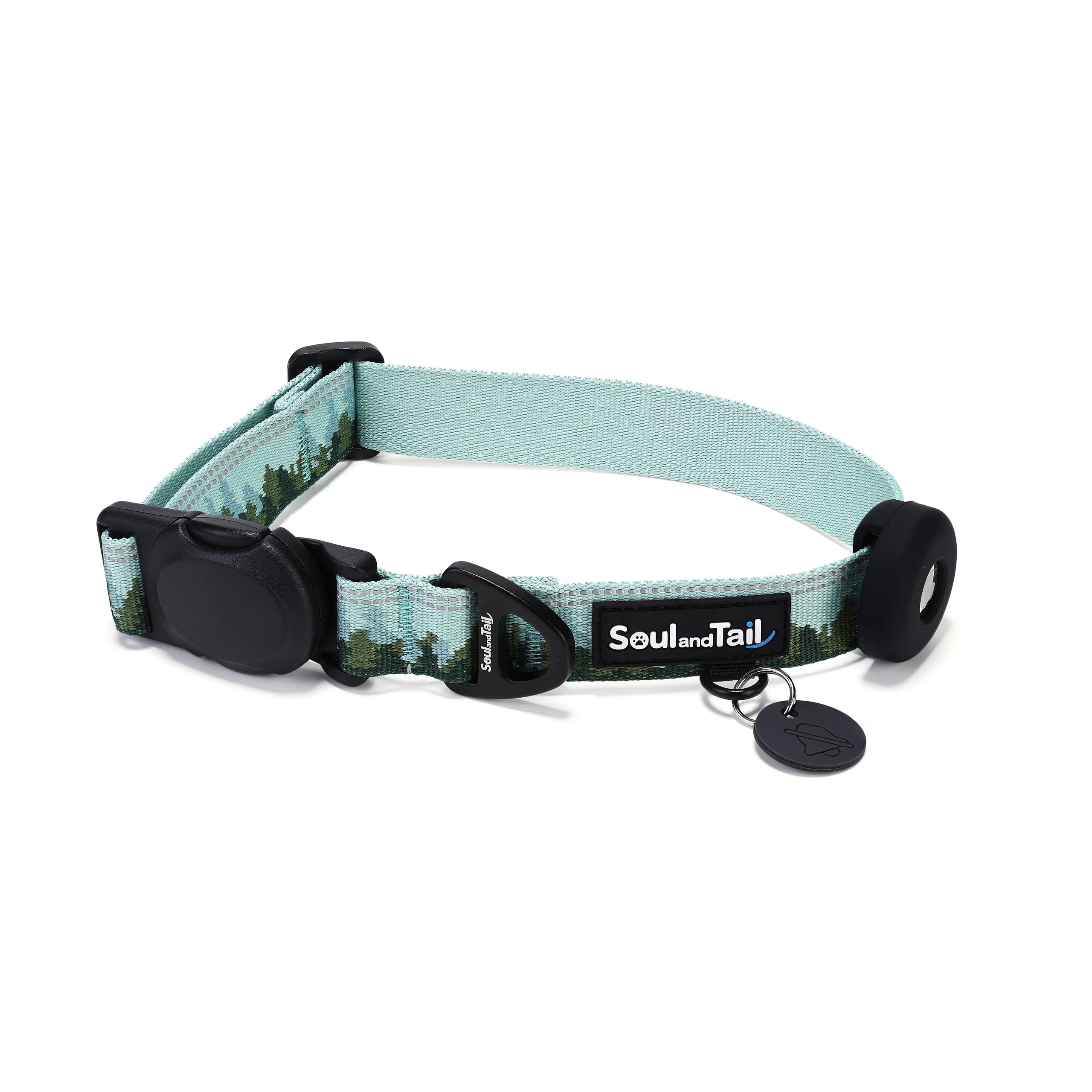 Green dog collar with forest mist pattern on its webbing, integrated with a black tag silencer, aluminum ring, silicon airtag holder, assembled by an black magnetic buckle on a white background