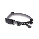 Gray dog collar with a black tag silencer, aluminum ring, silicon airtag holder, assembled by a black magnetic buckle on a white background