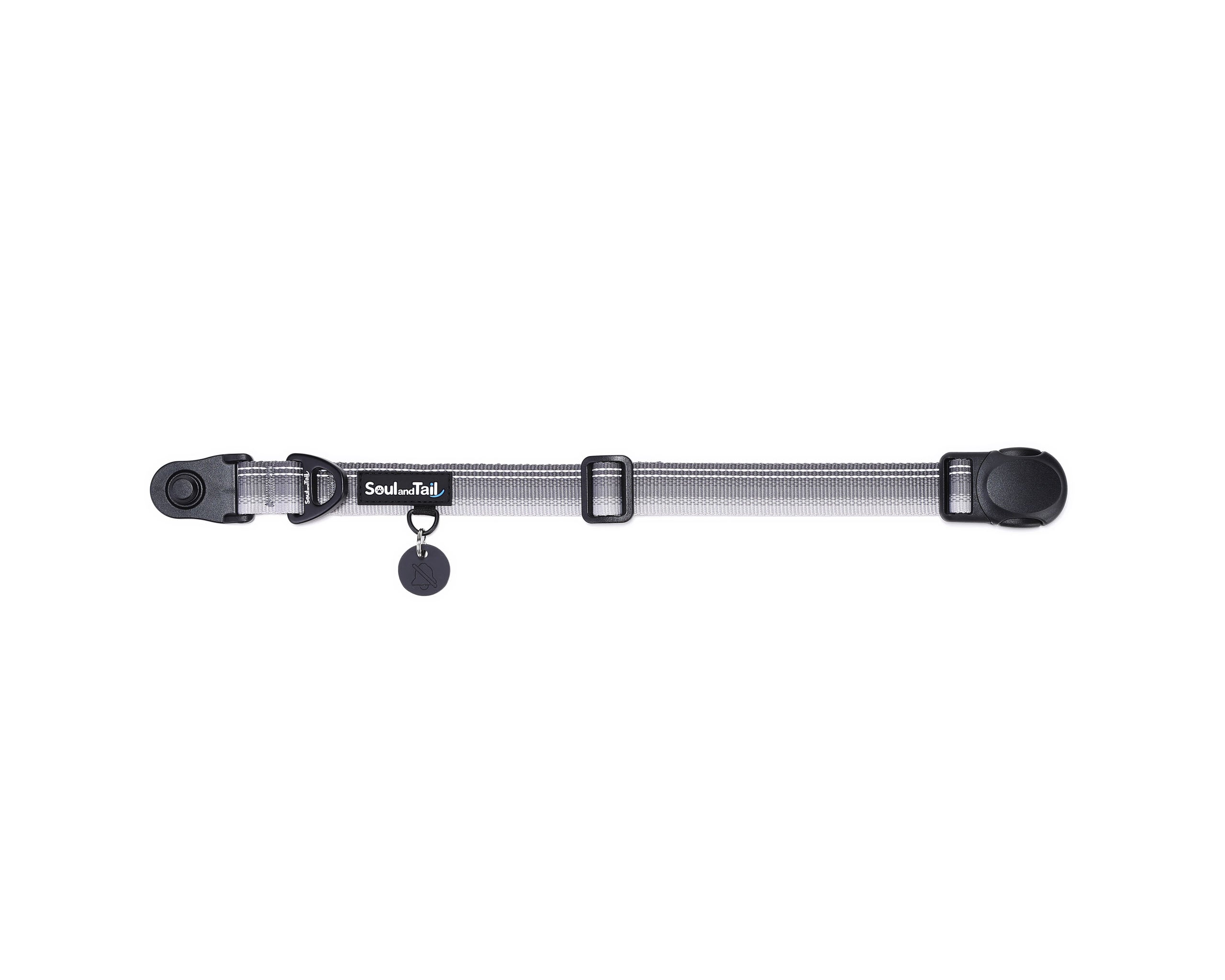 Gray dog collar with a black tag silencer, aluminum ring, silicon airtag holder, with the black magnetic buckle fully opened and lying on a white background