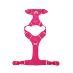 Pink dog harness lying flat on a white background