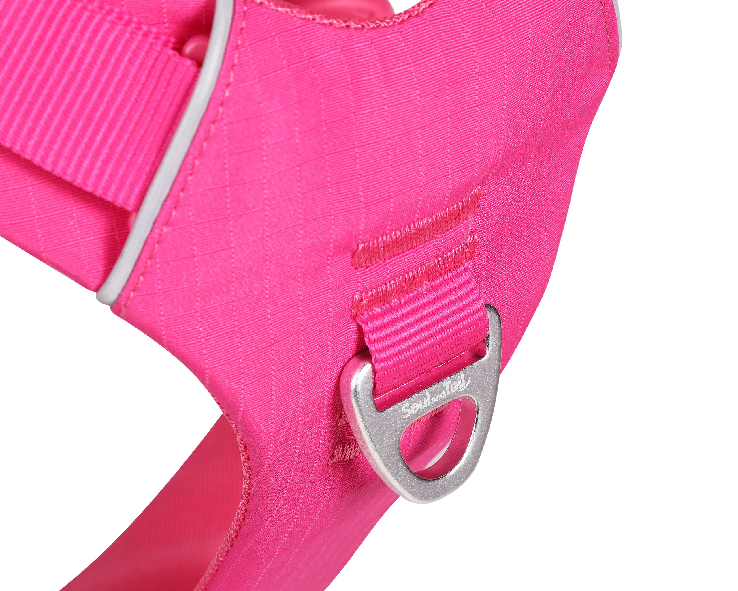 Close-up of a pink dog harness with an aluminum front ring with the logo "Soul and Tail" on a white background