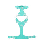 Turquoise dog harness with its magnetic buckle fully opened lying a white background