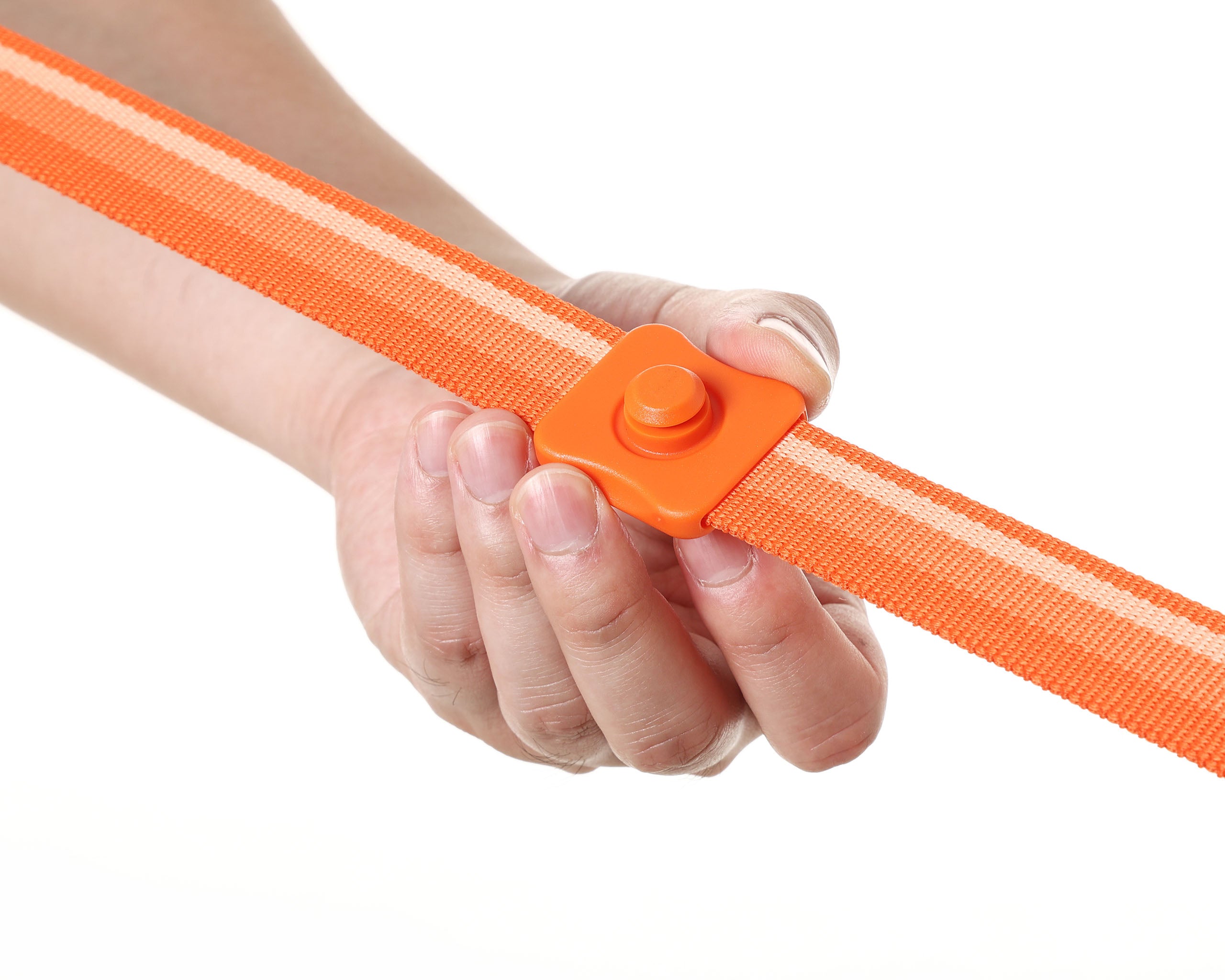 Hand holding an orange strap with a sliding buckle base on a white background