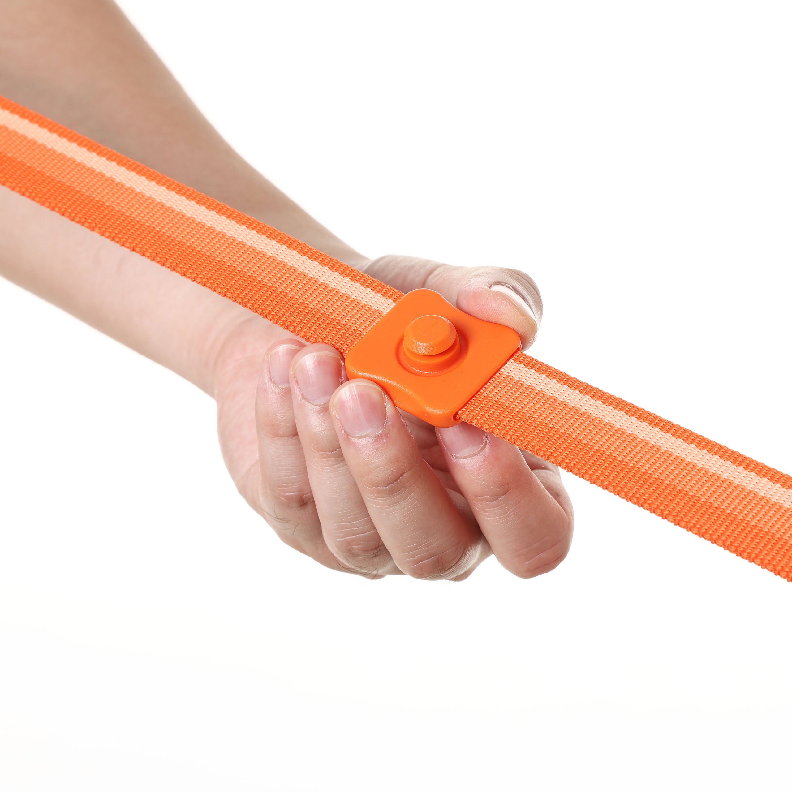 Hand holding an orange strap with a sliding buckle base on a white background