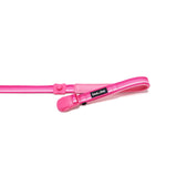 Pink dog leash with a opned magnetic buckle lying flat on a white background