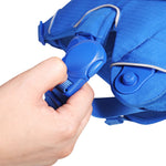 Hand adjusting a blue strap on a blue harness, trying to close the magnetic buckle, against a white background