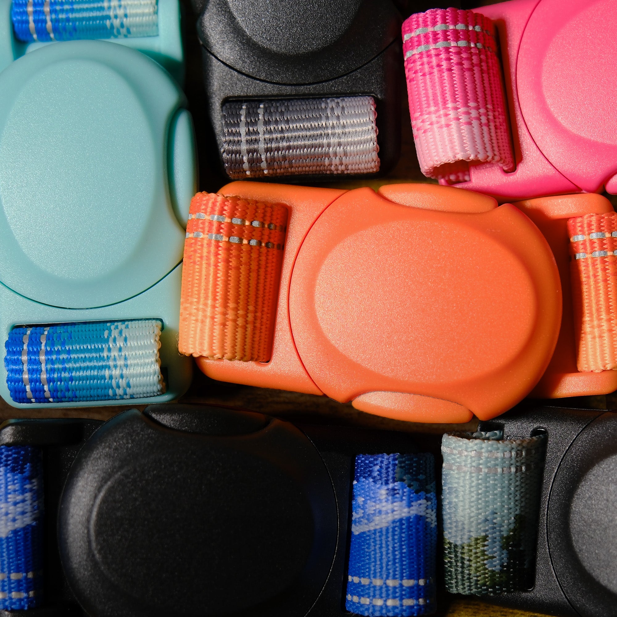 Collection of colorful magnetic buckles with lanyards gathered up on a flat surface