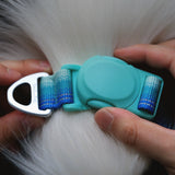Turquoise dog collar's mint green magnetic buckle being adjusted on a white dog